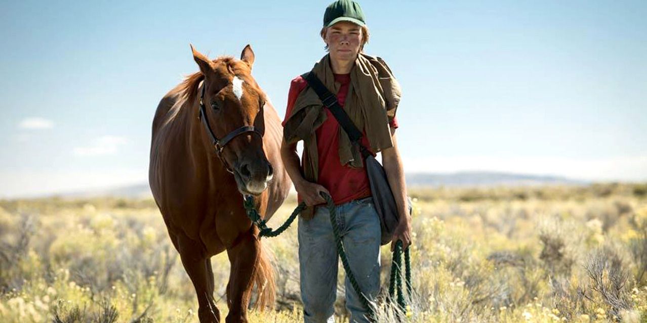 Charlie Plummer walking with Pete, the horse, in Lean On Pete