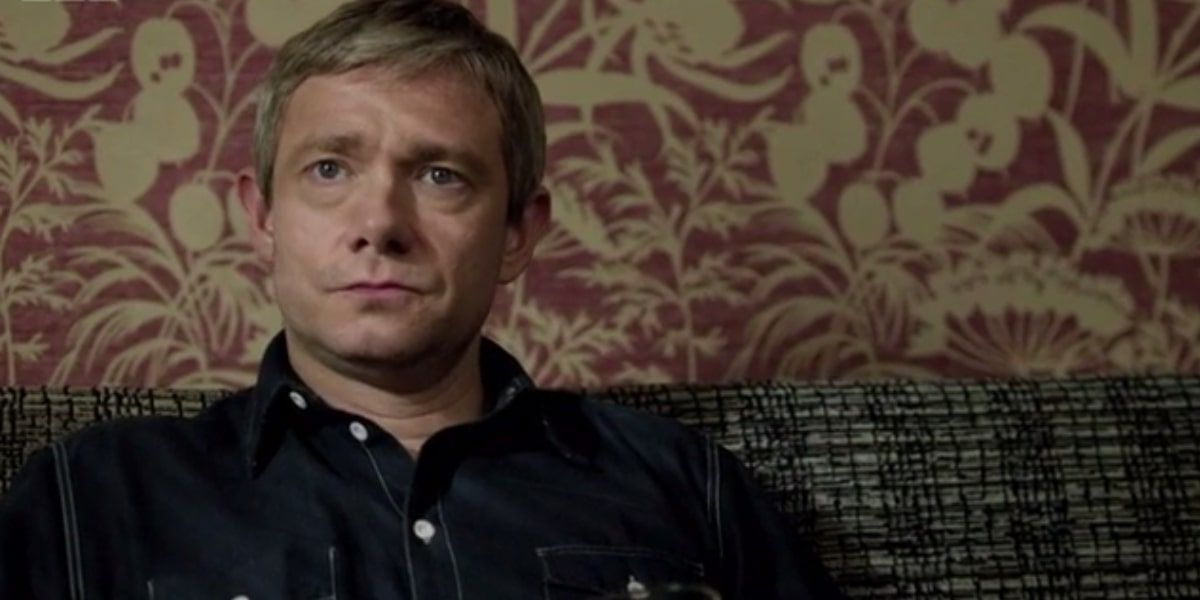 Watson sitting down and looking serious in Sherlock