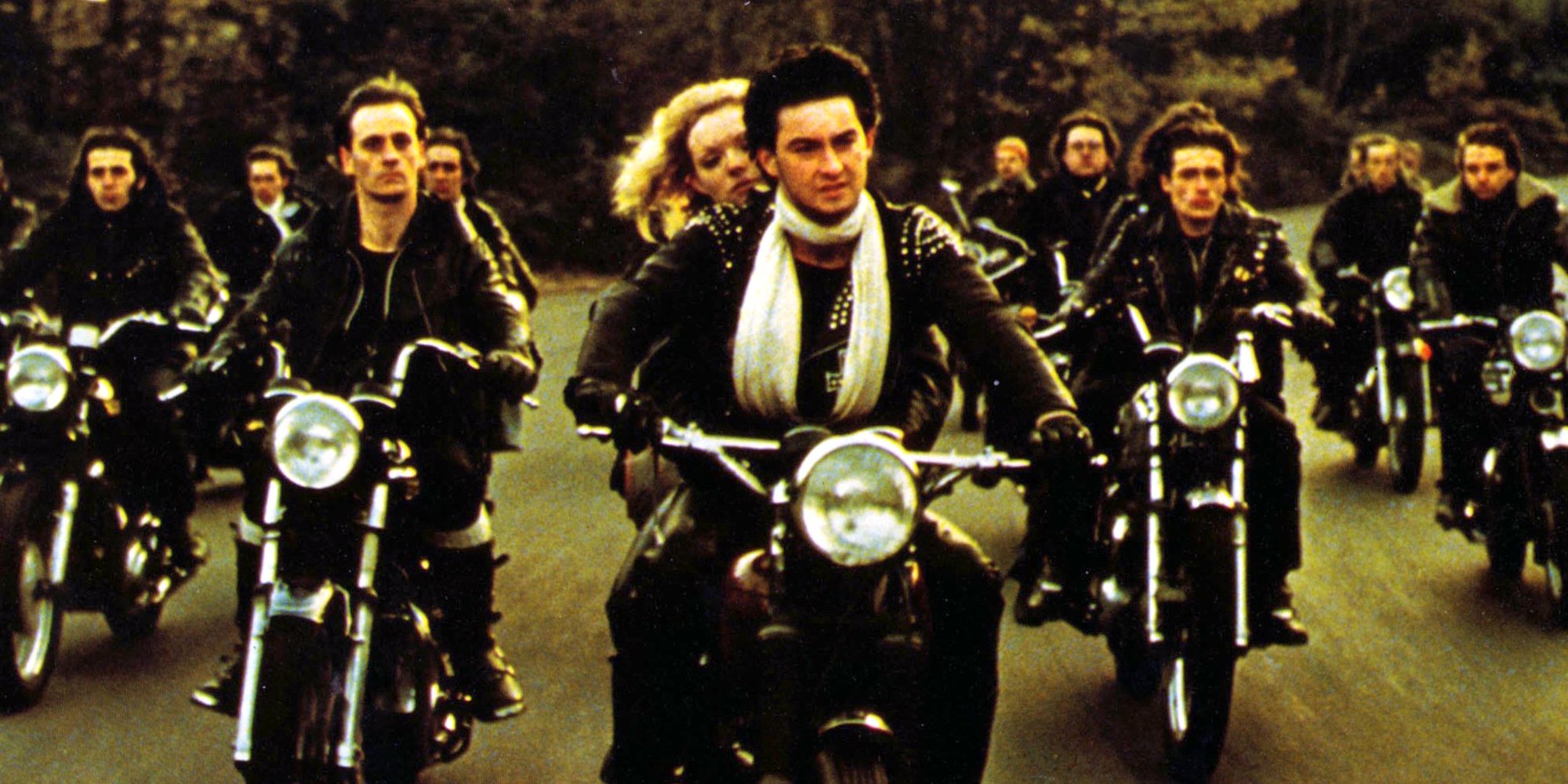 A gang of scooter riders drive down a road from Quadrophenia 