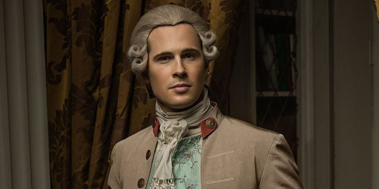 Lord John Grey looking seriously at someone off camera in Outlander