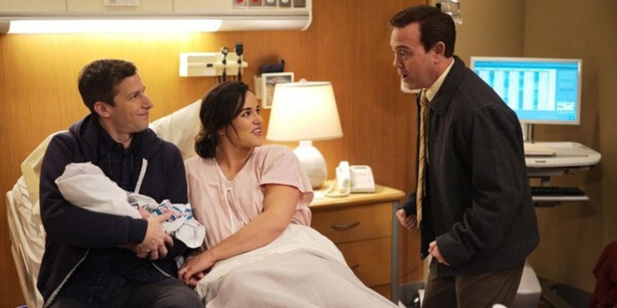 Jake and Amy introducing their newborn to Charles