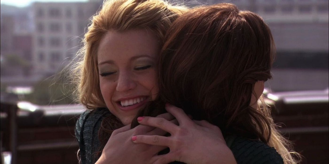 Serena and Blair hug on a rooftop in Gossip Girl.