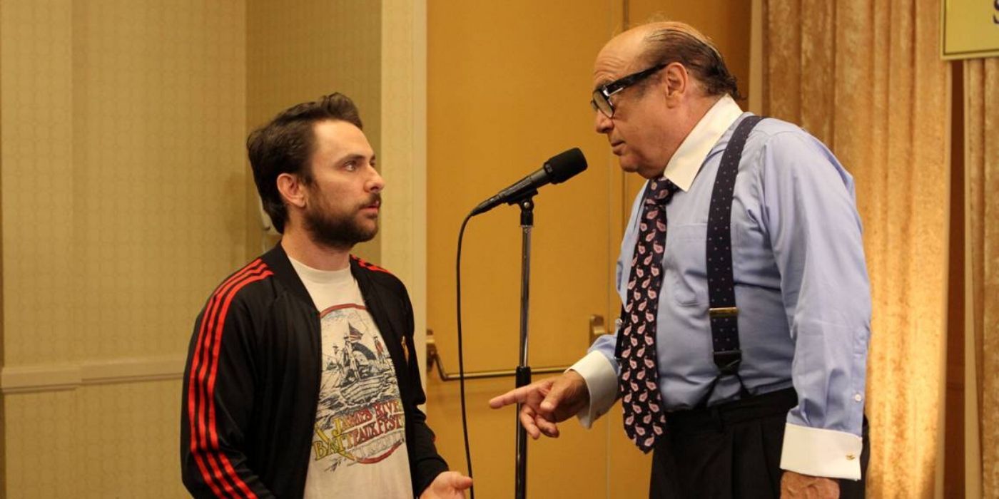 Frank gives a speech dressed in business attire while Charlie questions him in It’s Always Sunny In Philadelphia