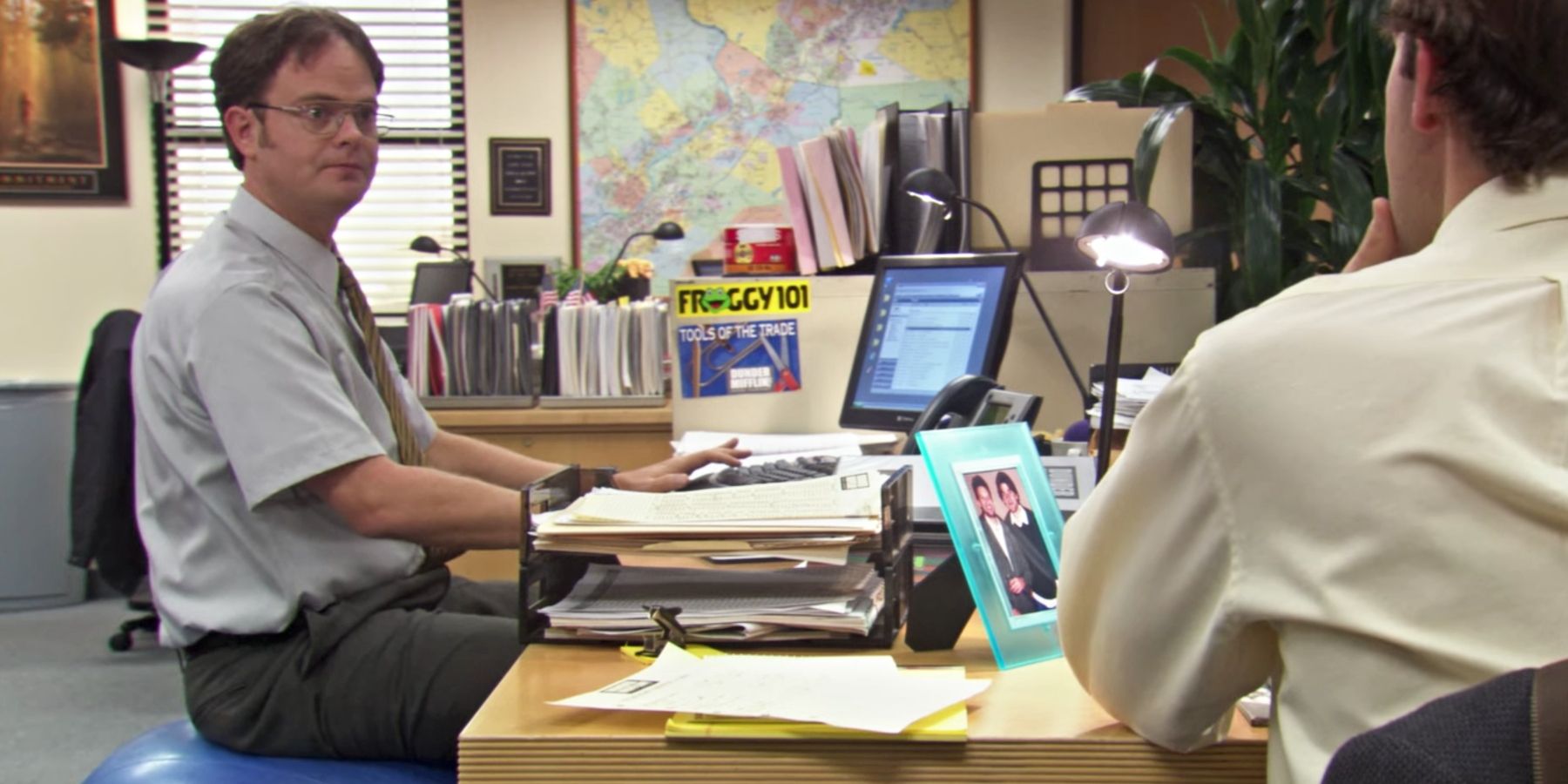 Dwight sitting on a fitness orb on The Office