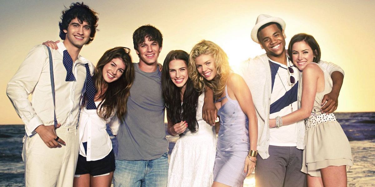 The main cast of 90210 posing for the camera on the beach