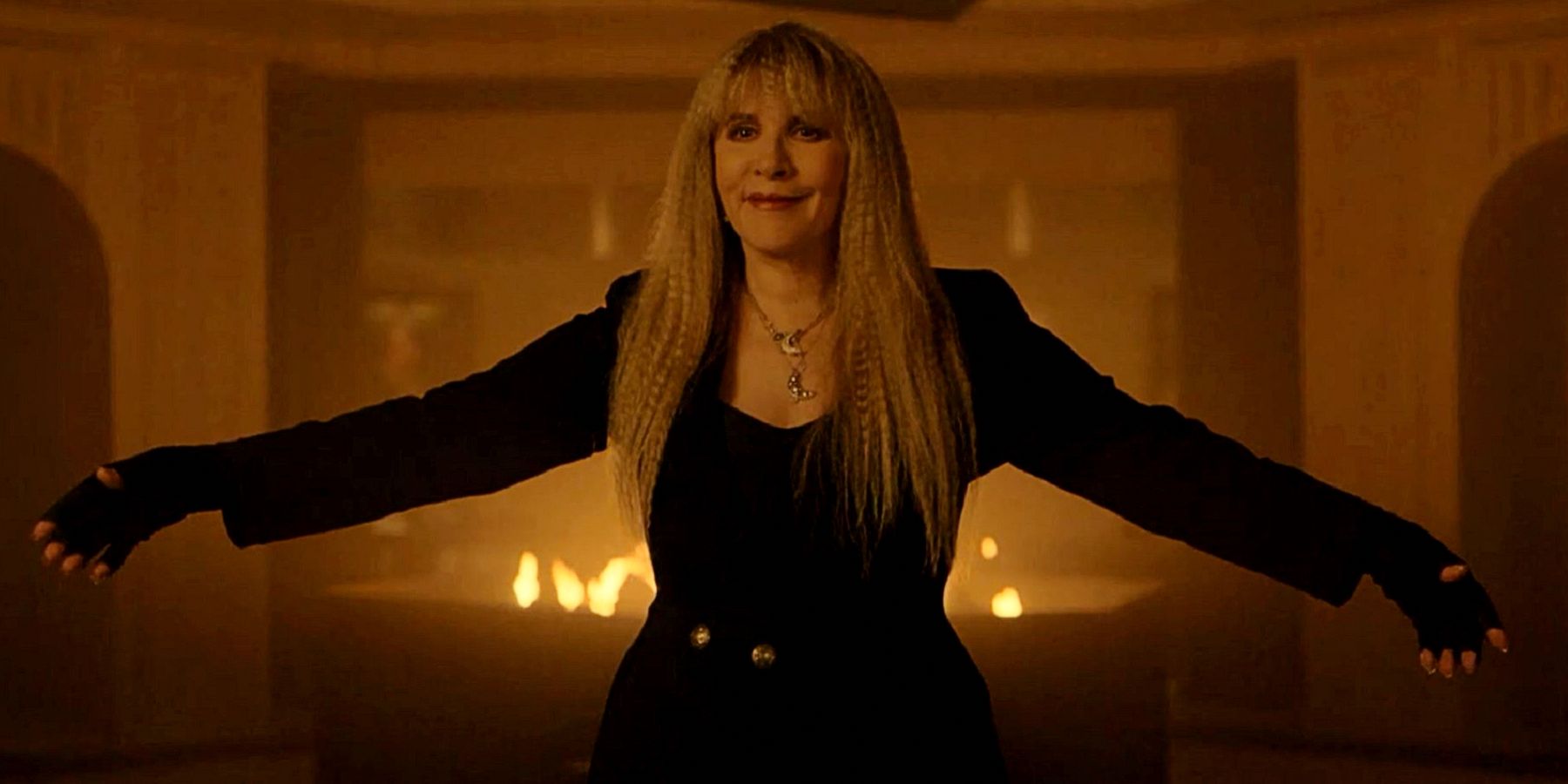Stevie Nicks stands with her arms wide from American Horror Story