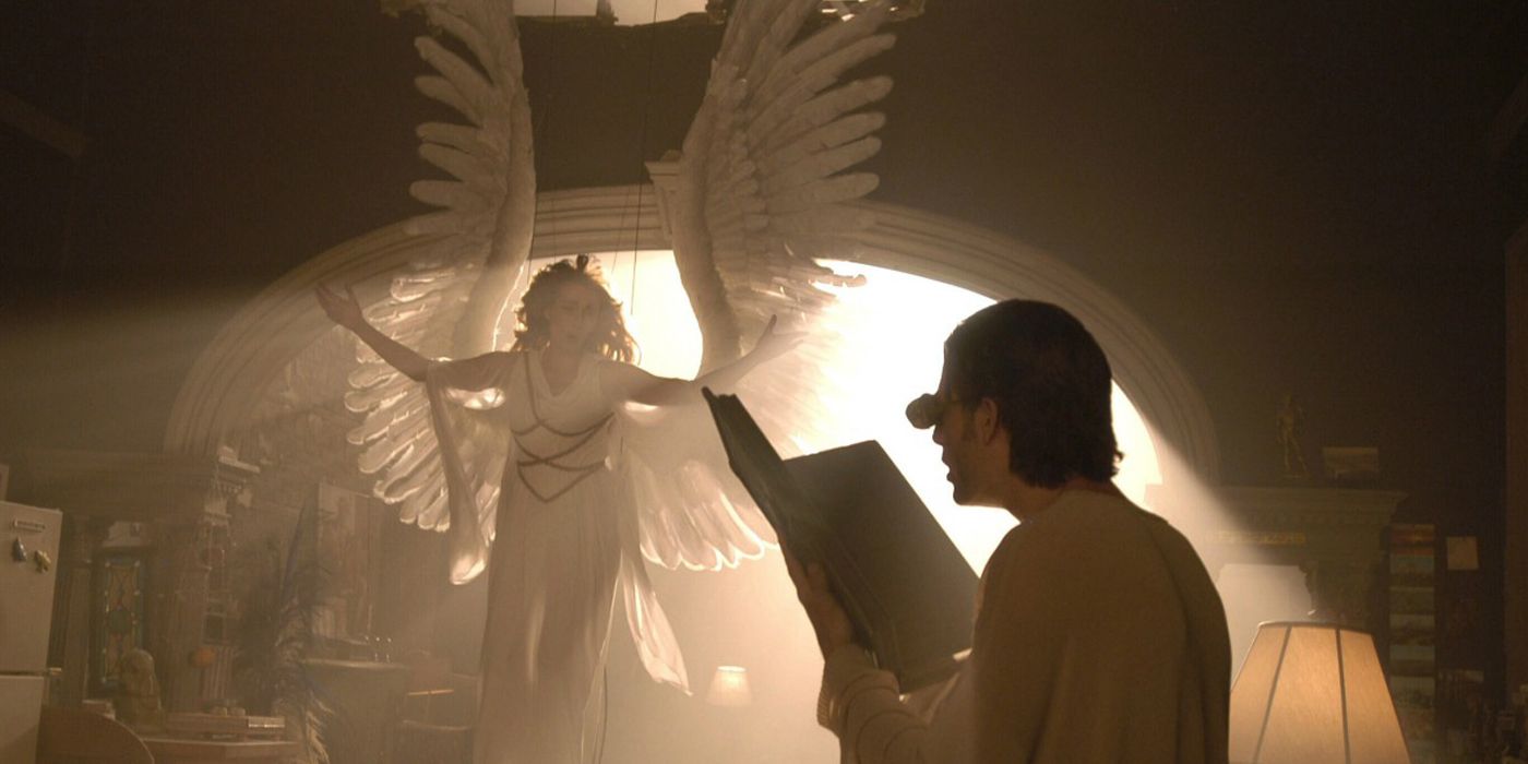 A man reads a big book and looks up at an angel in Angels in America