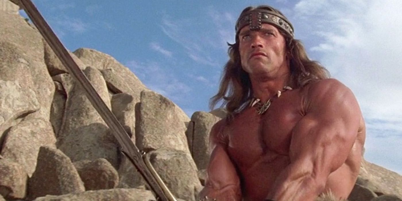 Arnold Schwarzenegger as Conan the Barbarian holding a sword