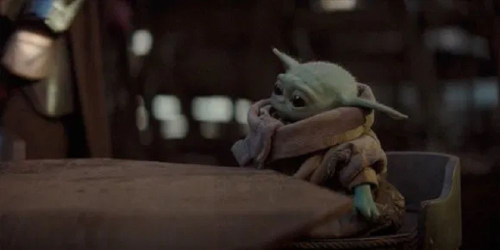 Baby Yoda sitting at table in The Mandalorian