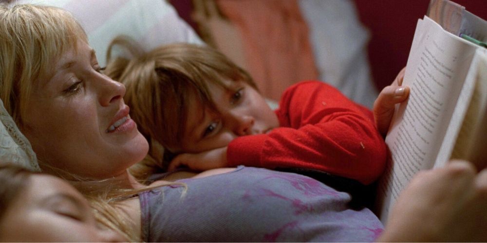 Two children listen as their mother reads to them in bed from the movie Boyhood