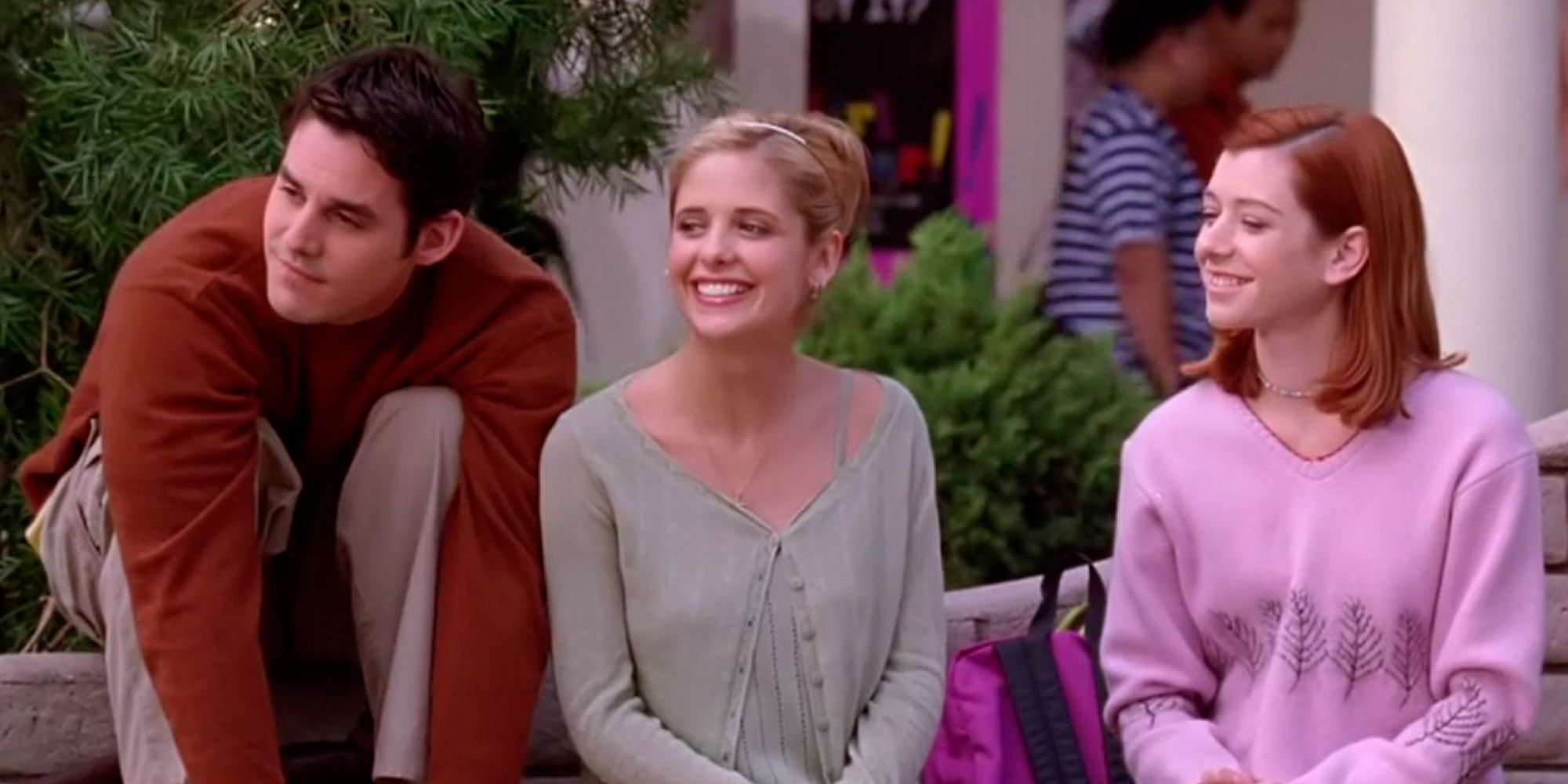 Xander, Buffy, and Willow sitting outside and smiling on Buffy The Vampire Slayer
