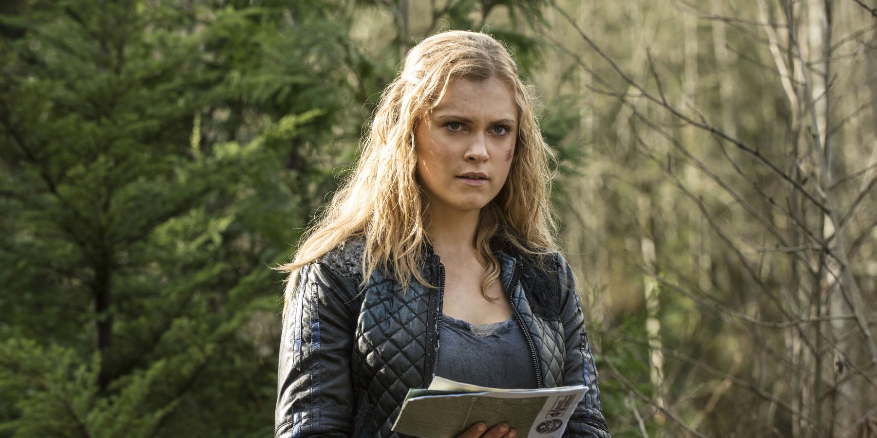 Clarke stands in the forest in The 100 season 2