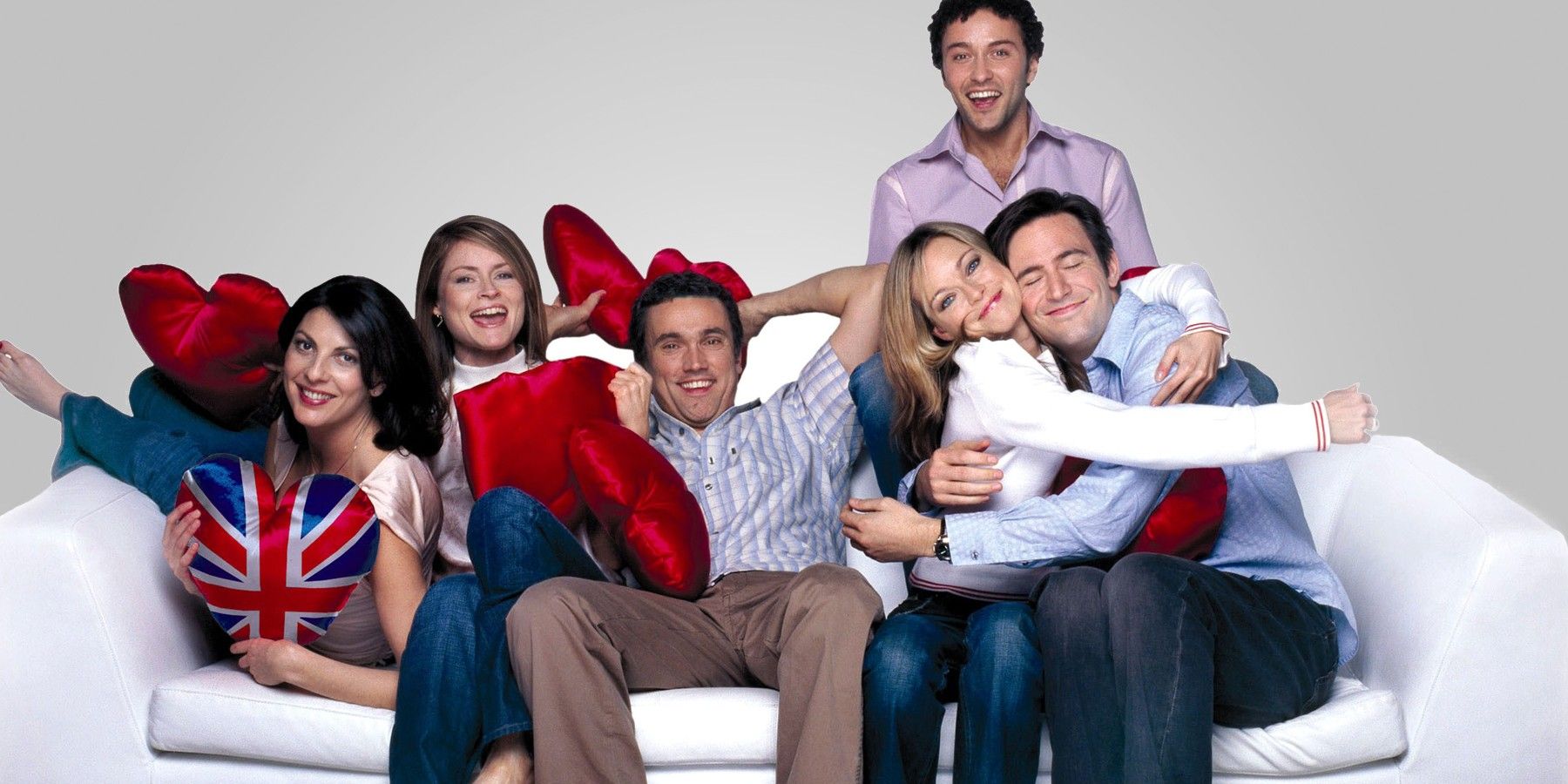 The cast of Coupling on a couch