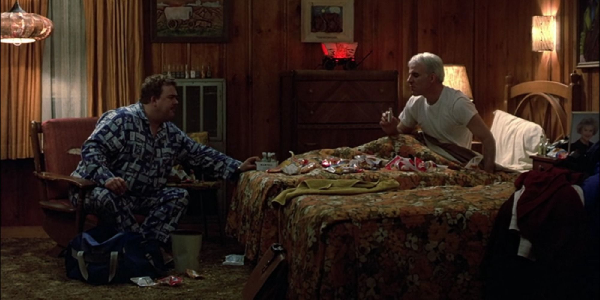 Del and Neal eating and drinking together in the motel room in Planes, Trains and Automobiles