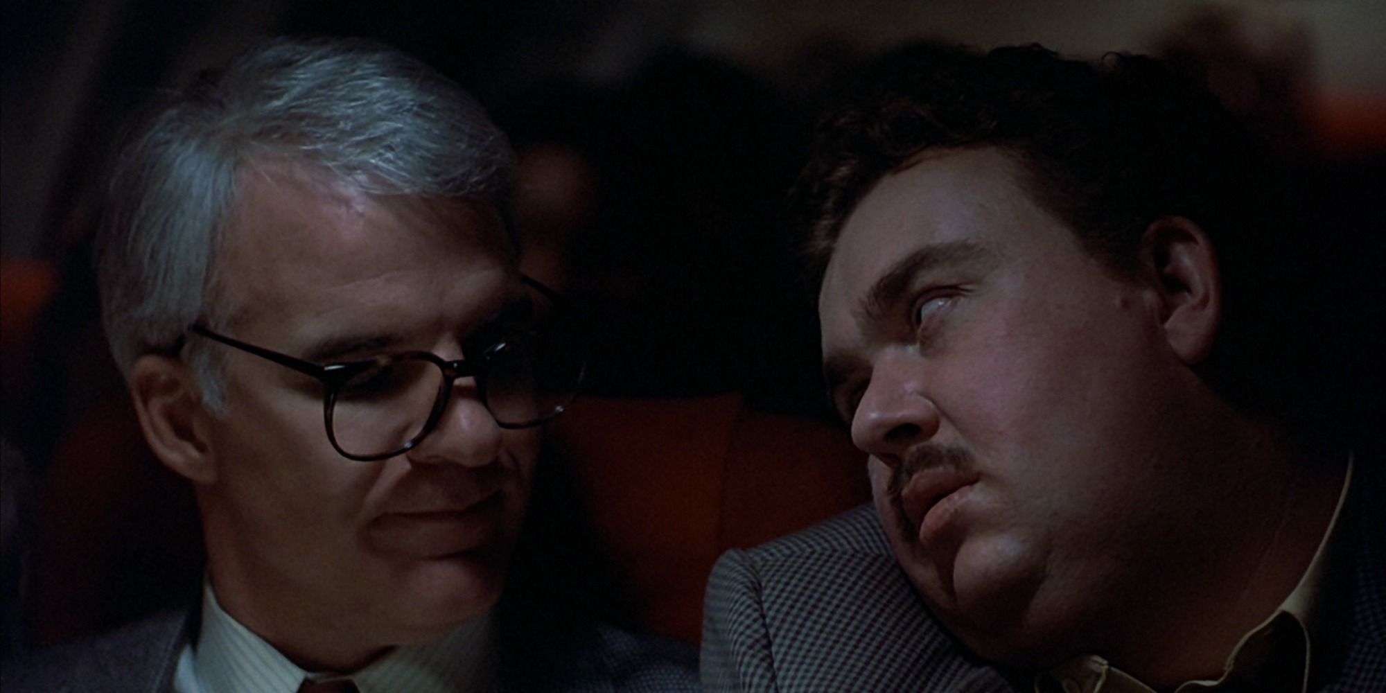 Del looking at Neal on the flight in Planes, Trains and Automobiles