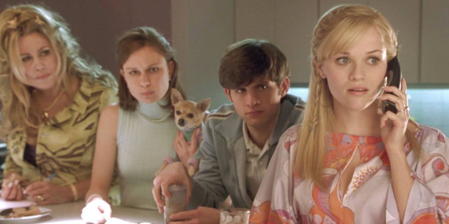 Elle takes a phone call while her friends wait behind hr in the kitchen in Legally Blonde 2
