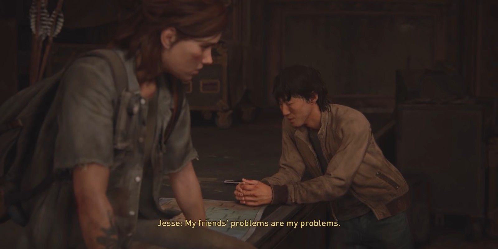 Jesse leans on a table as Ellie looks at him in The Last of Us Part II.