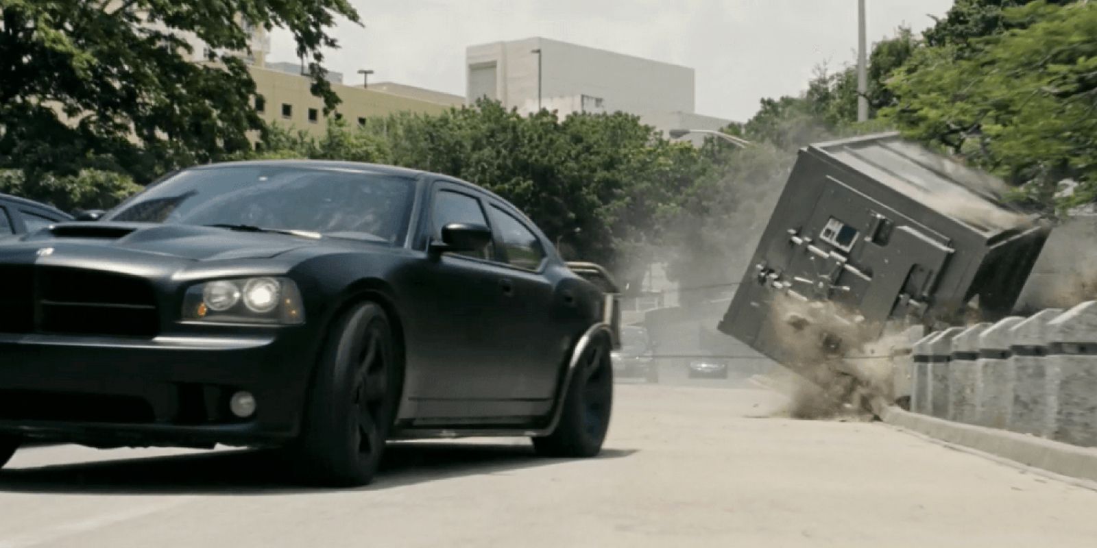 A car drags a vault through the streets in Fast Five