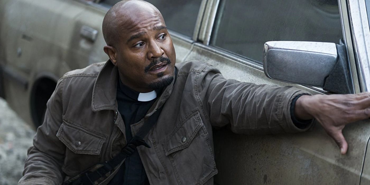 Father Gabriel sitting by a car on The Walking Dead.