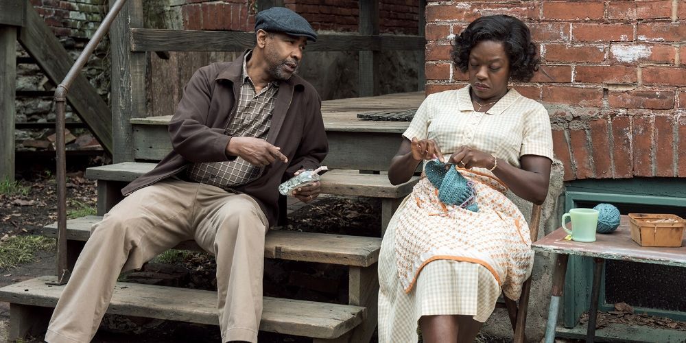 Denzel and Viola davis sit on porch steps in Fences