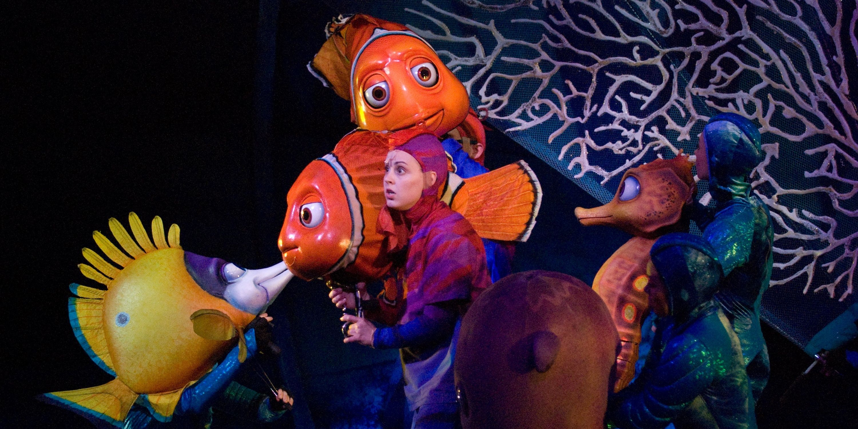 Puppeteers holding Nemo and Marlin