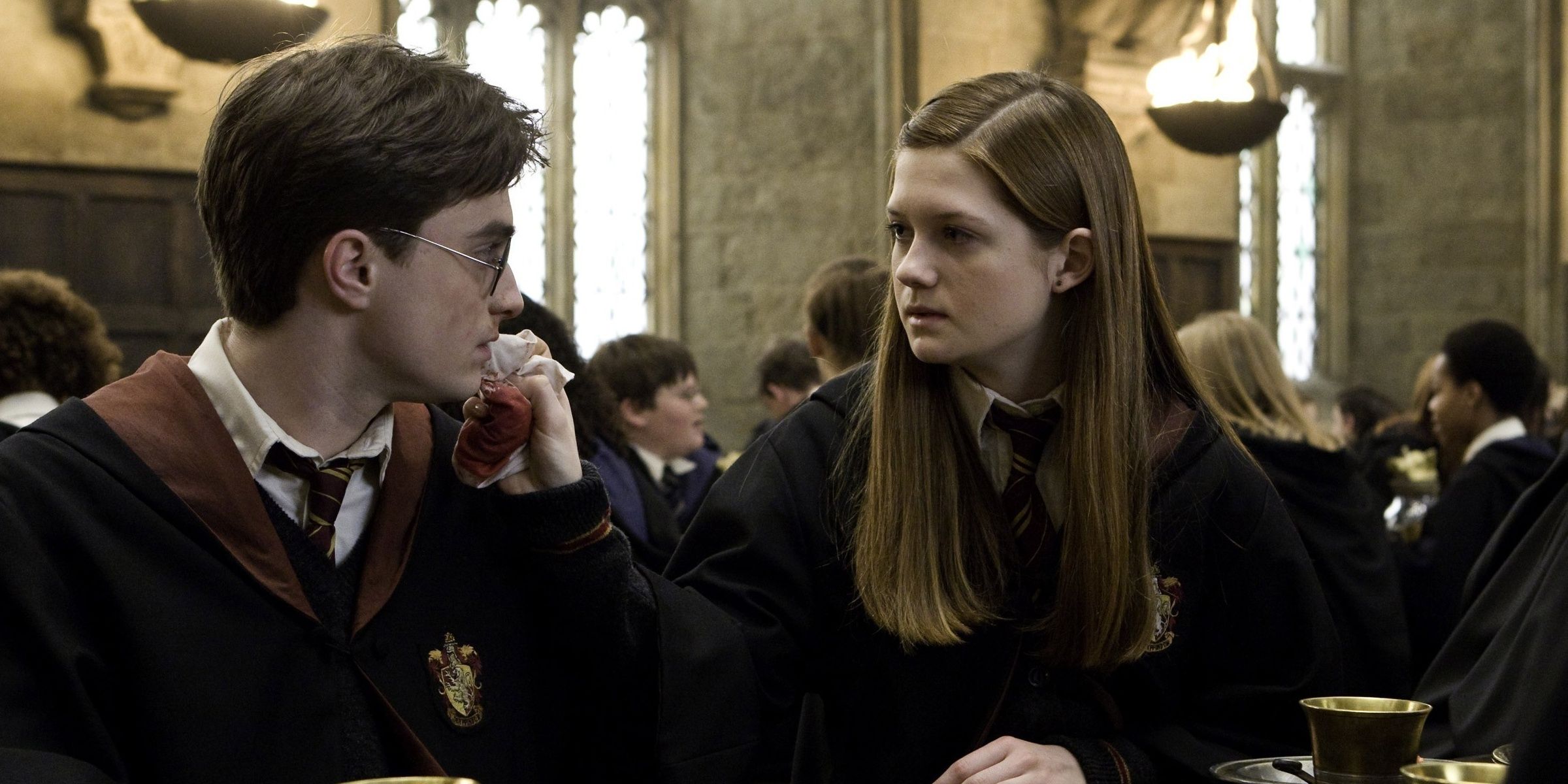 Ginny Weasley sitting next to Harry Potter in the Great Hall of Hogwarts