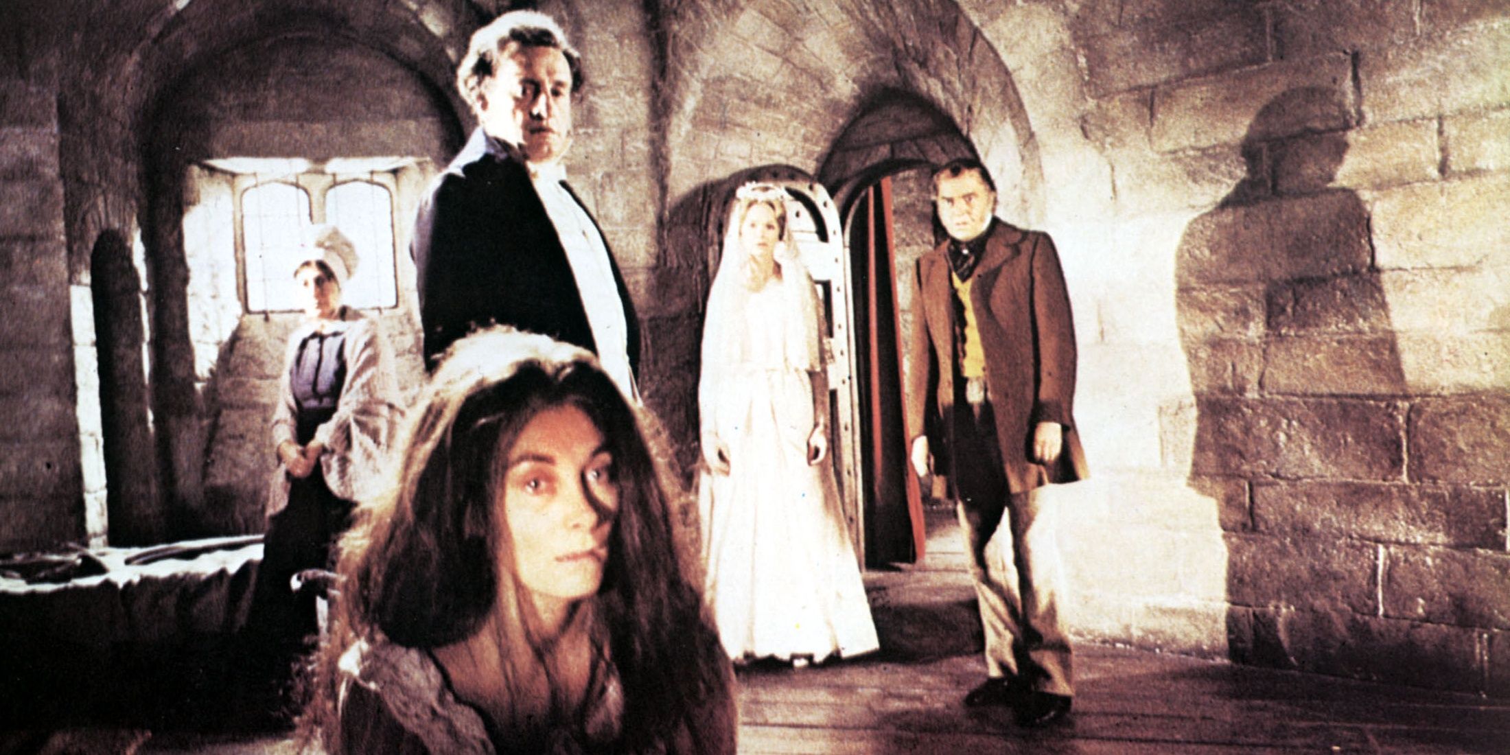 Two men and three women in a stone room in the 1970 version of Jane Eyre