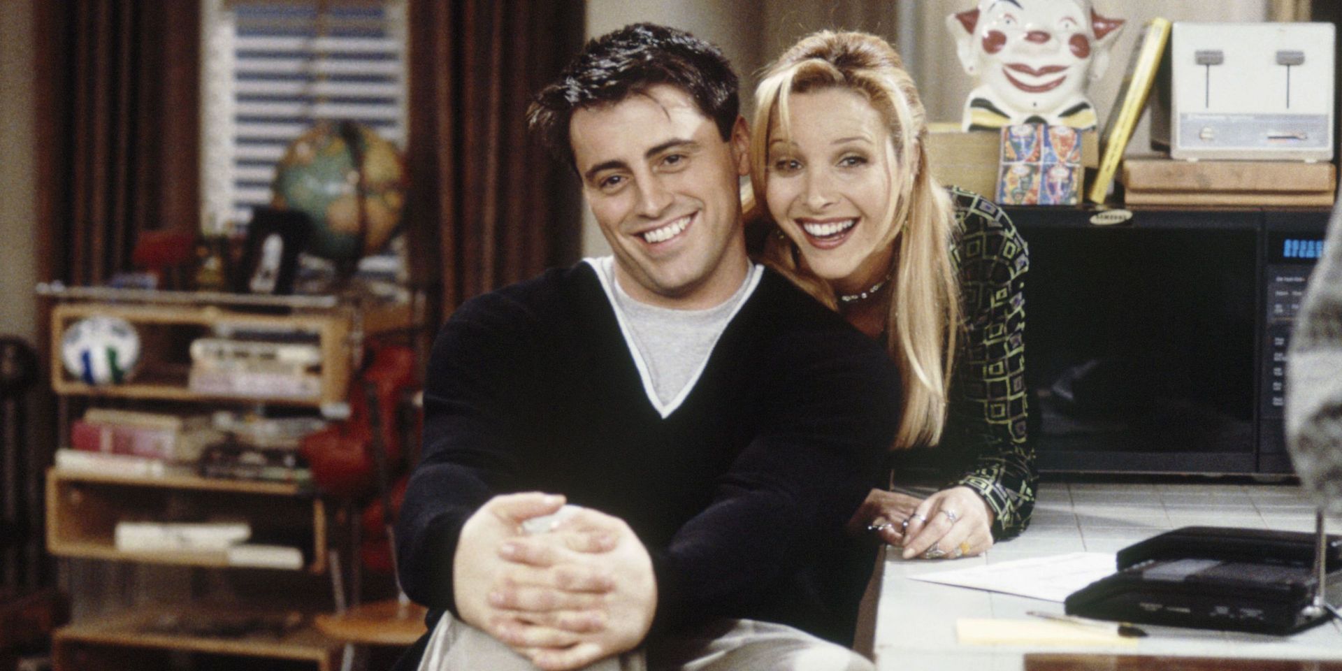 Joey and Phoebe looking at the camera and smiling in Friends