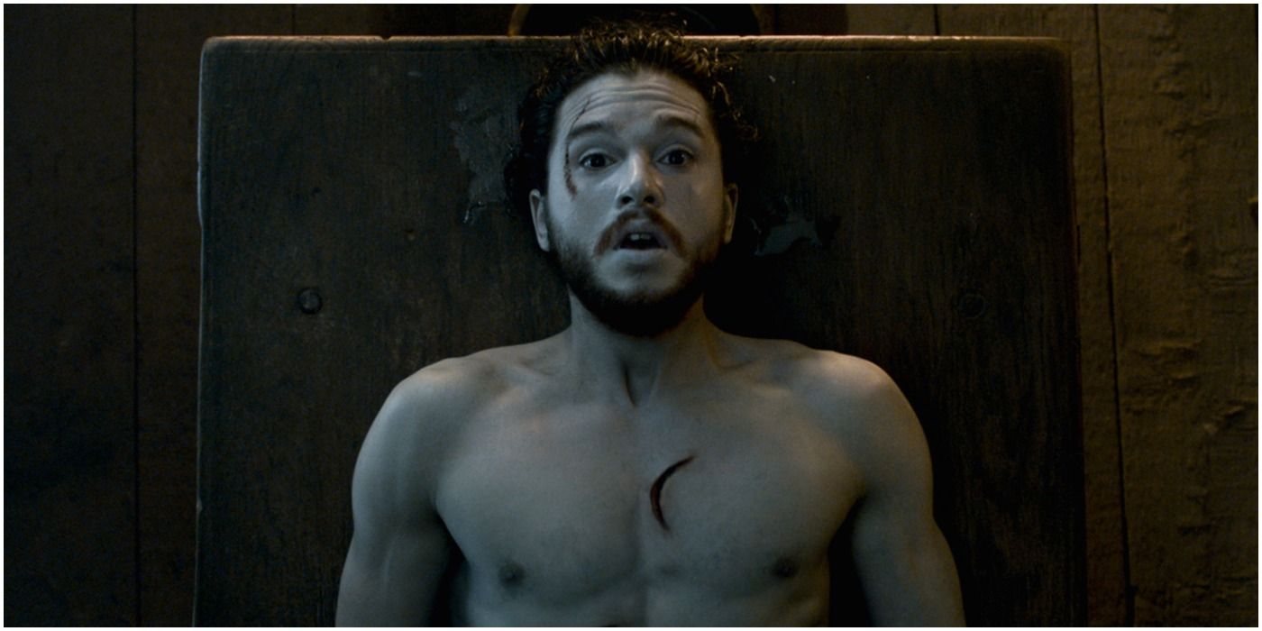 Jon Snow opens his eyes on the table in Game of Thrones
