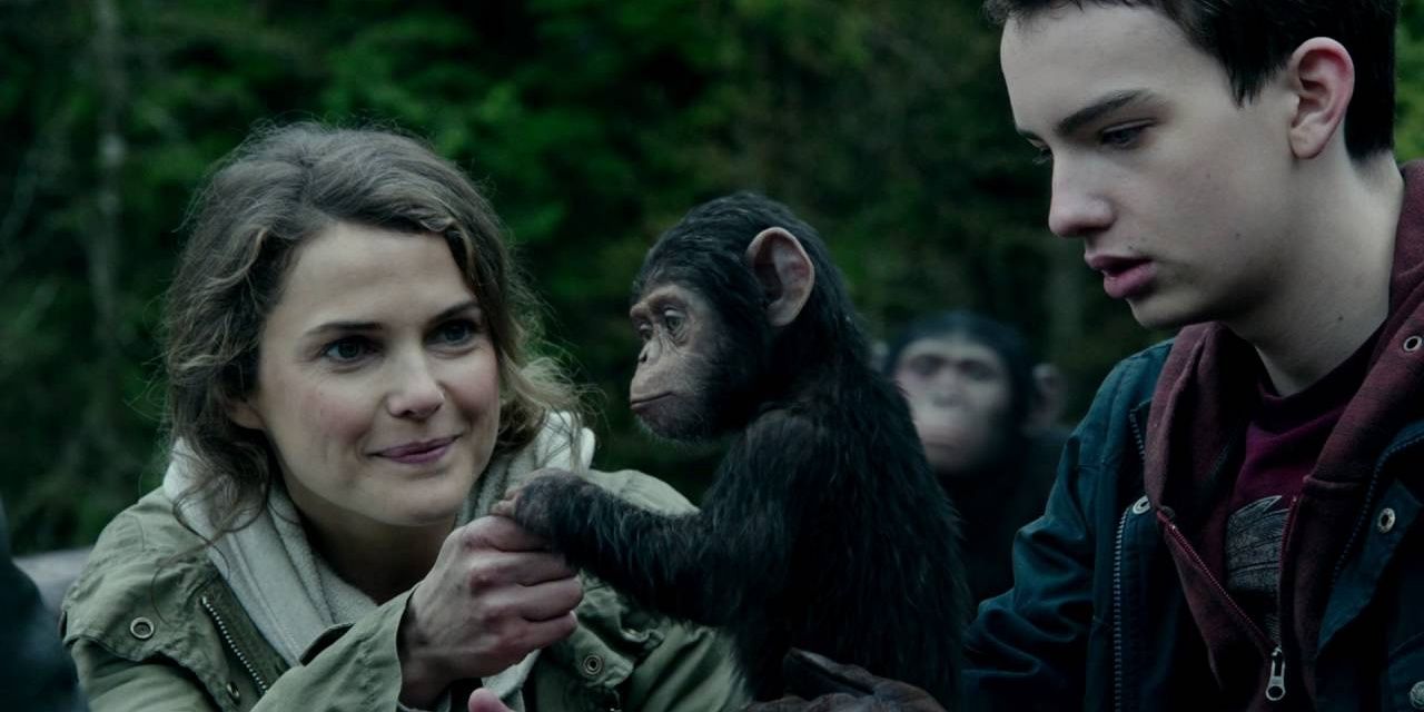 Mother and son with baby ape in Dawn Of The Planet Of The Apes