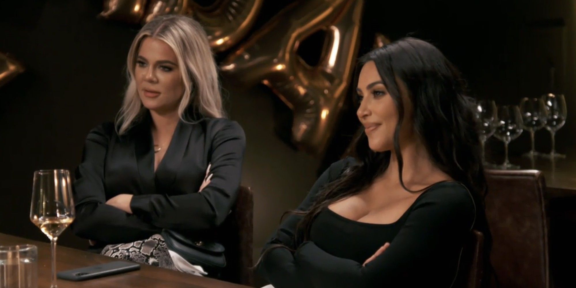 Khloe and Kim Kardashian sitting together in KUWTK