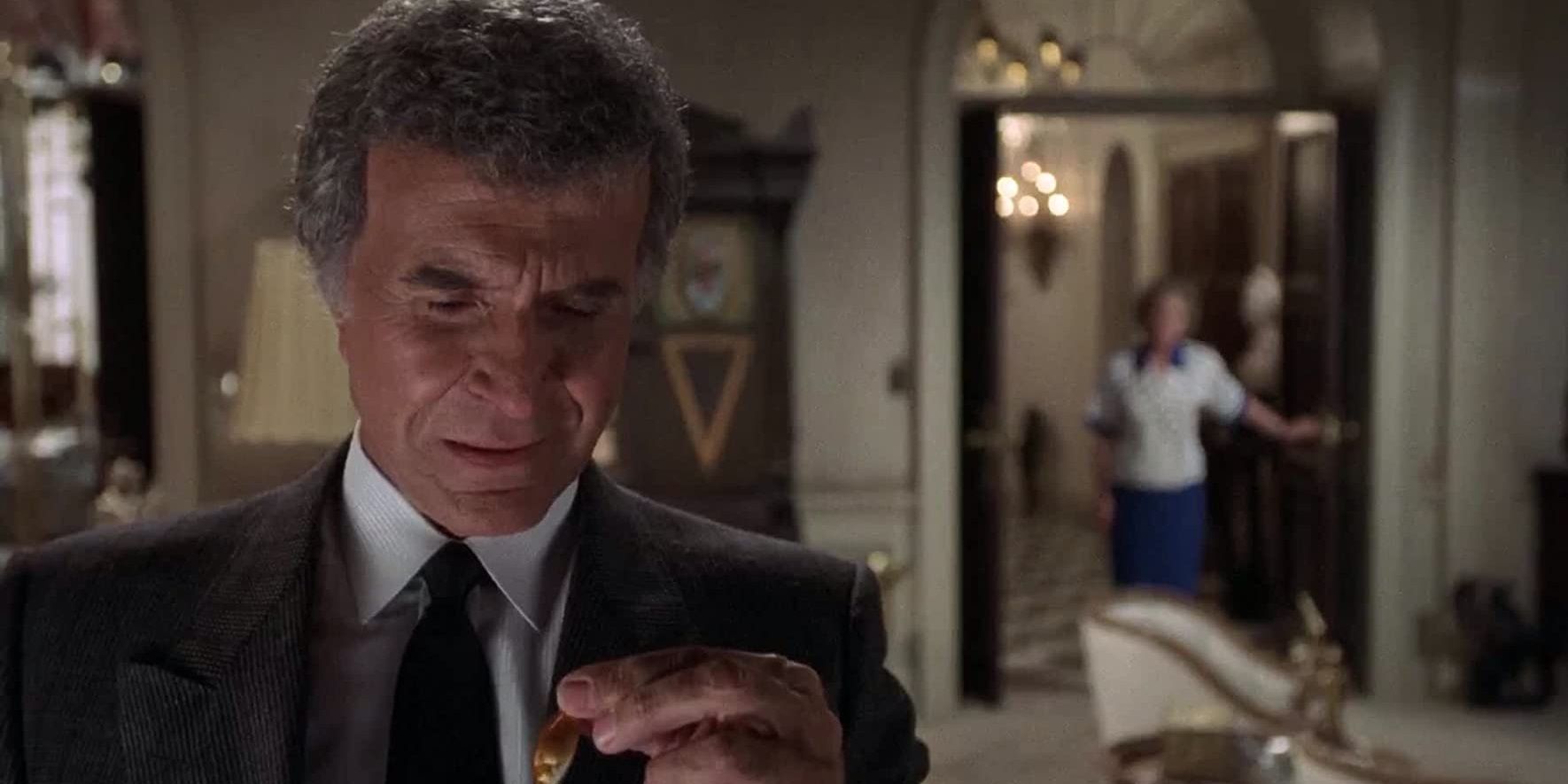Ludwig looking down at his hand in The Naked Gun