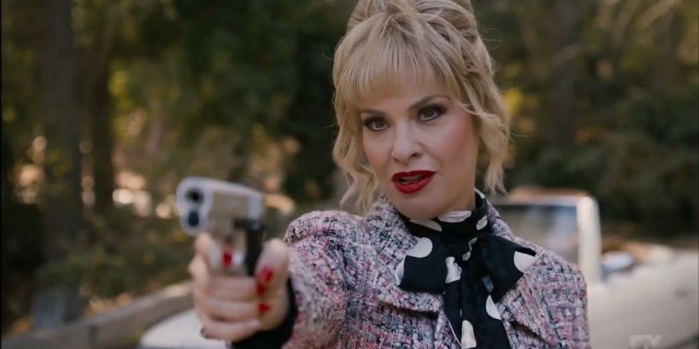 Margaret Booth pointing a gun in American Horror Story