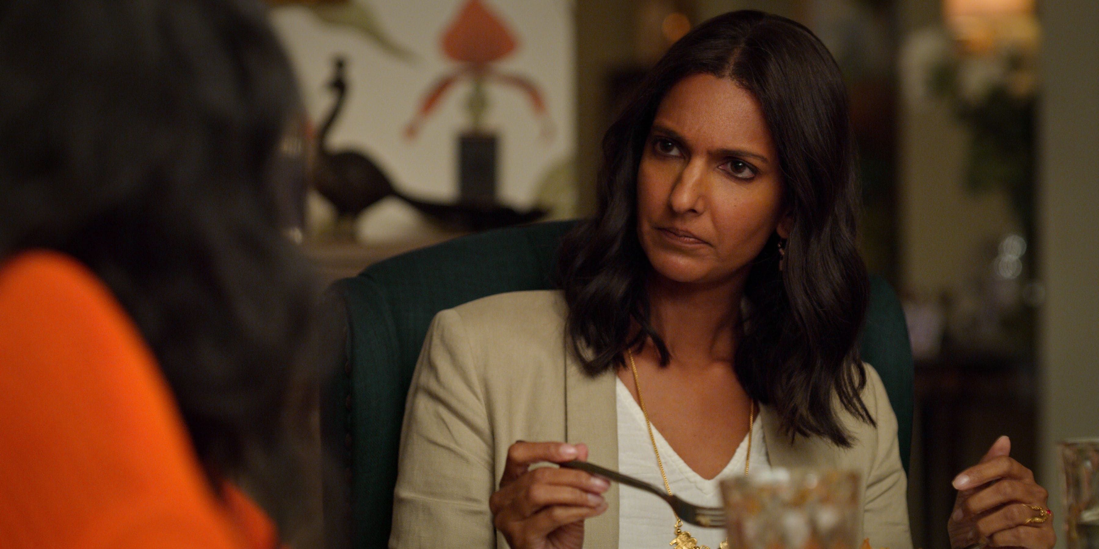 Nalini looks at Devi in confusion at dinner in Never Have I Ever