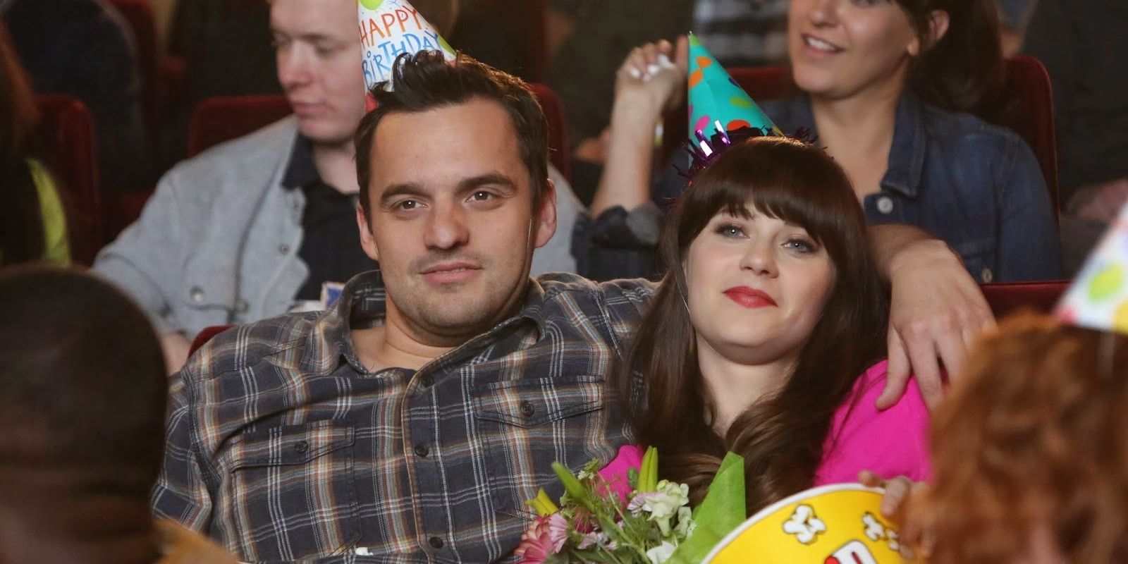 Nick with his arm around Jess in the theater in the New Girl episode Birthday
