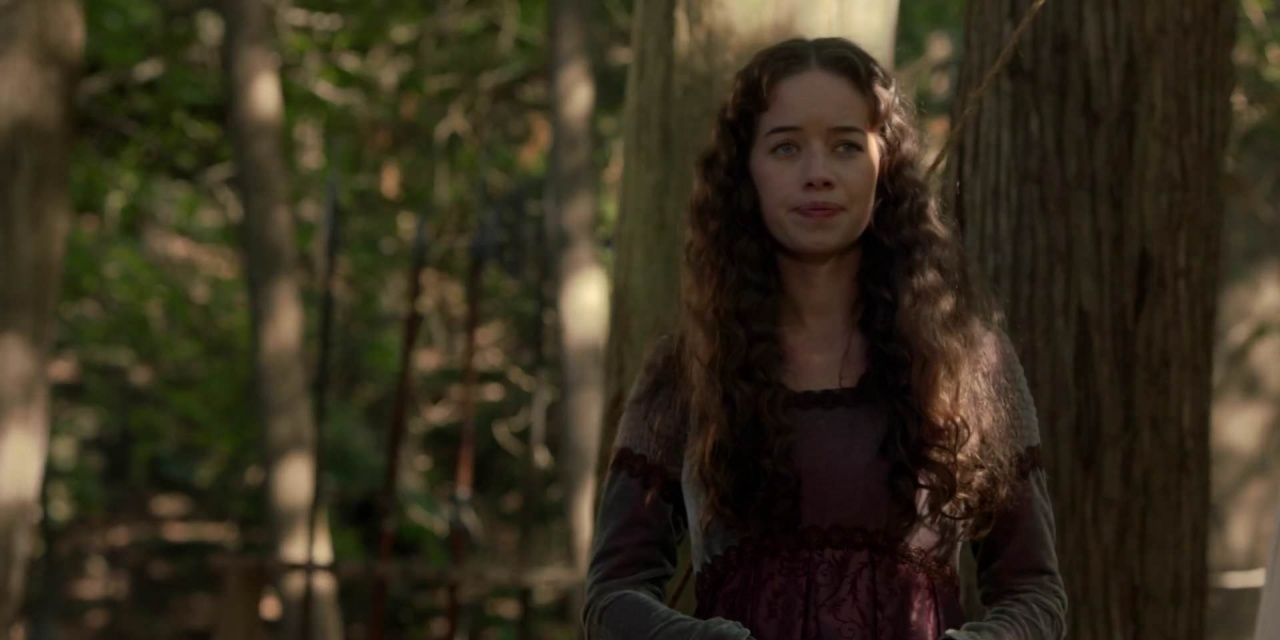 Lola appears concerned in the woods in Reign