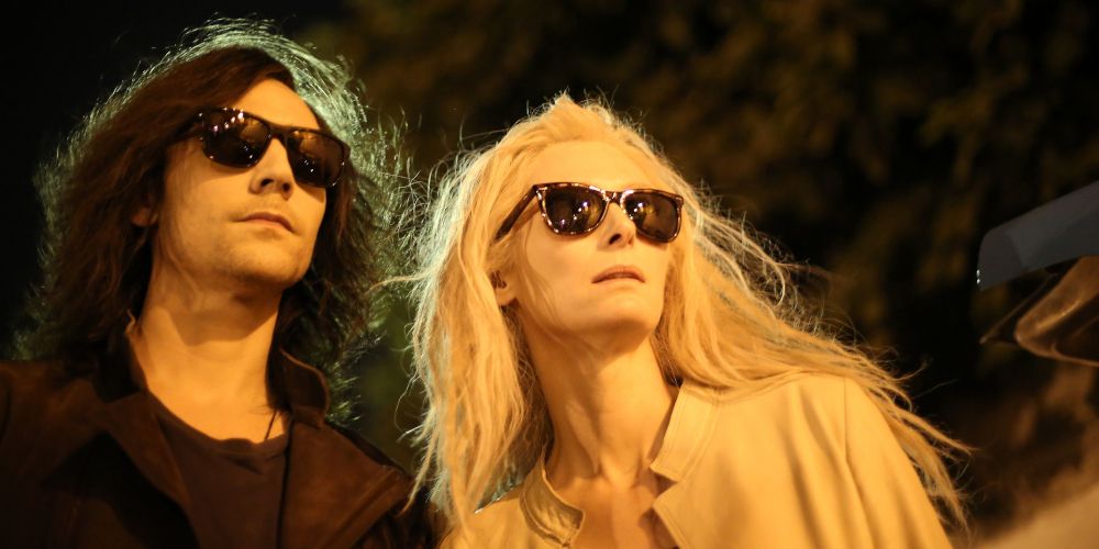 Tom Hiddleston and Tilda Swinton walking together and wearing sunglasses in Only Lovers Left Alive