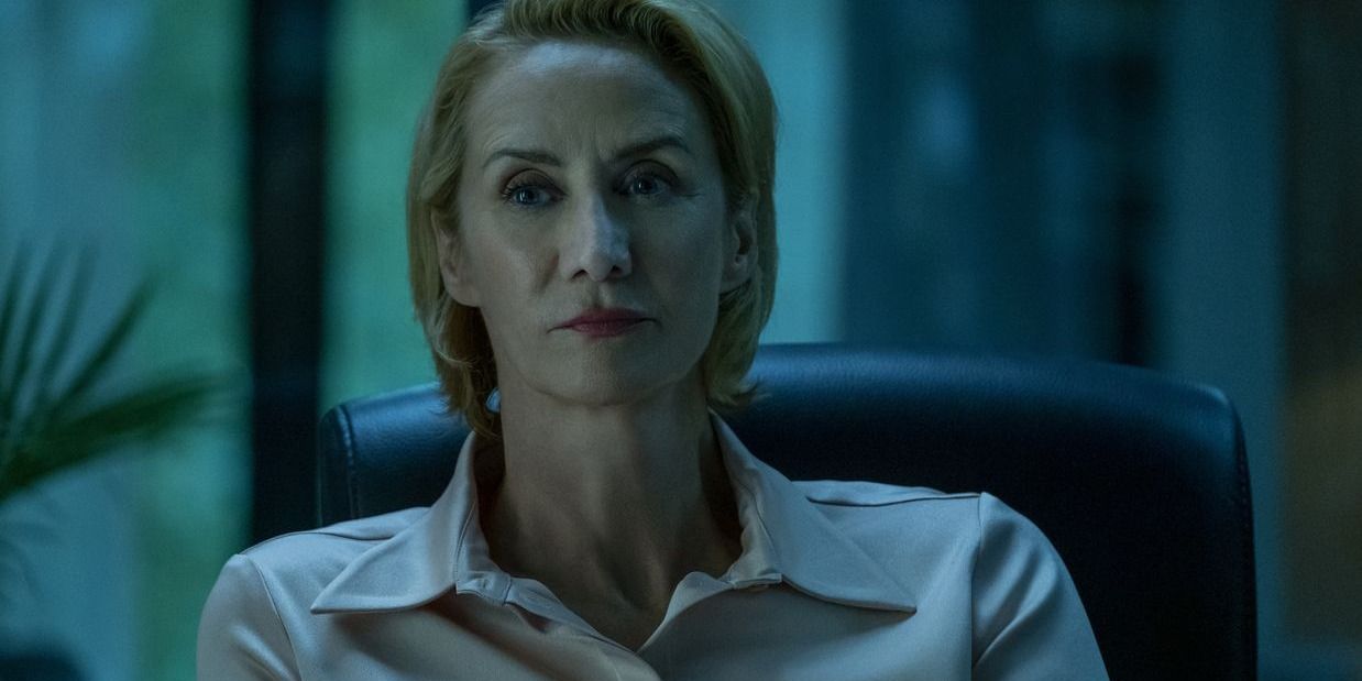 Helen sitting at desk with villainous expression in Ozark.
