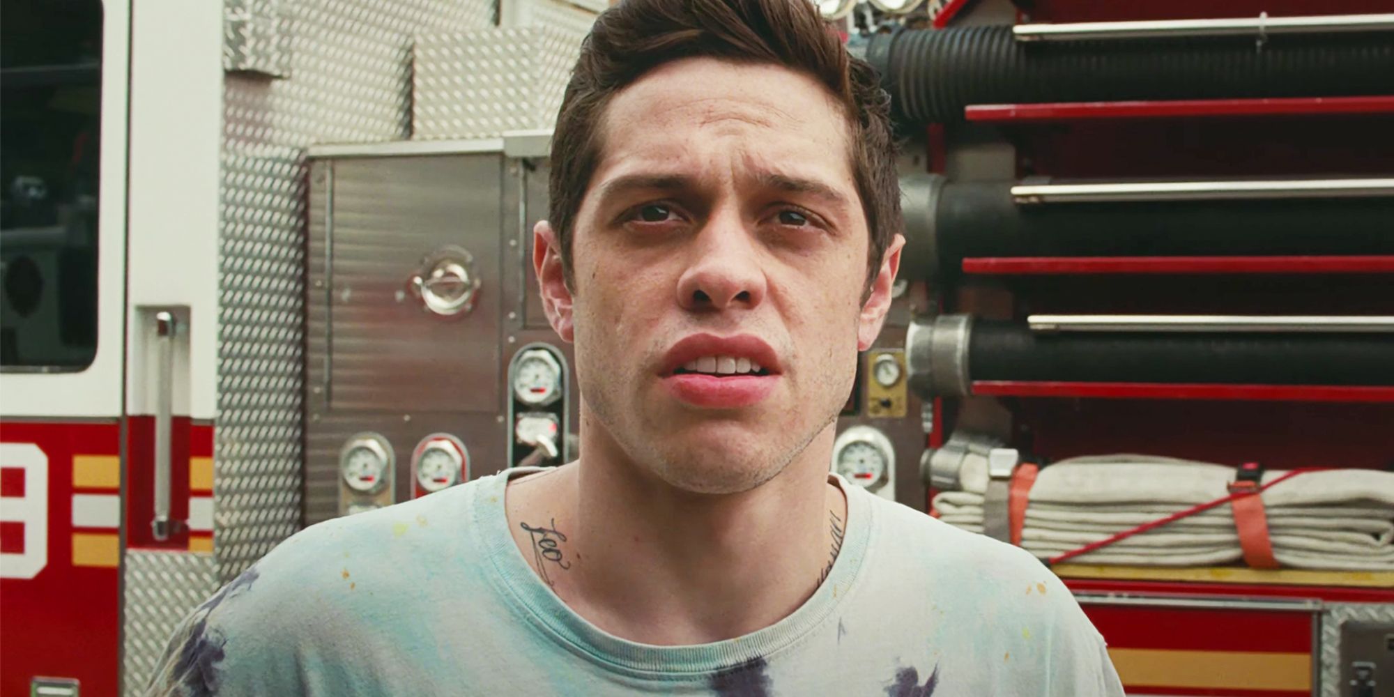 Pete Davidson stands in front of a fire truck in The King of Staten Island