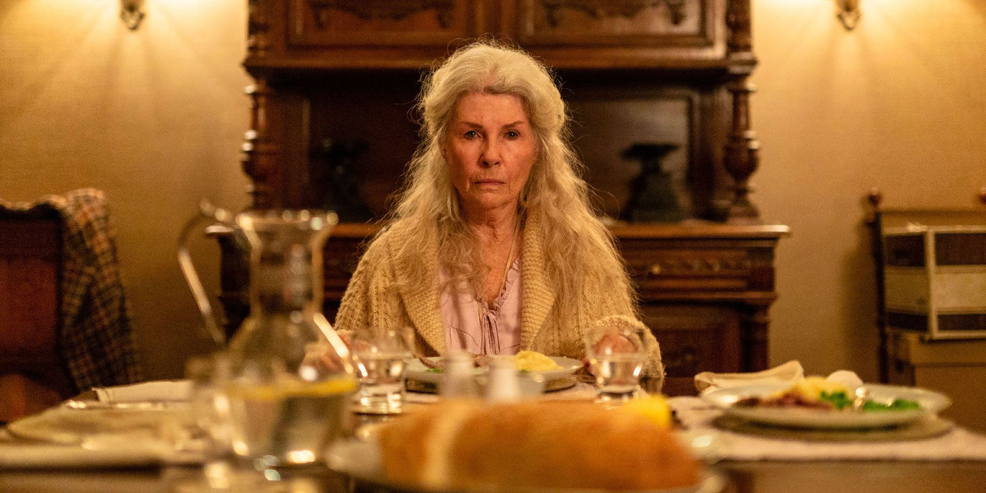 Robyn Nevin as Edna sitting at a table in Relic