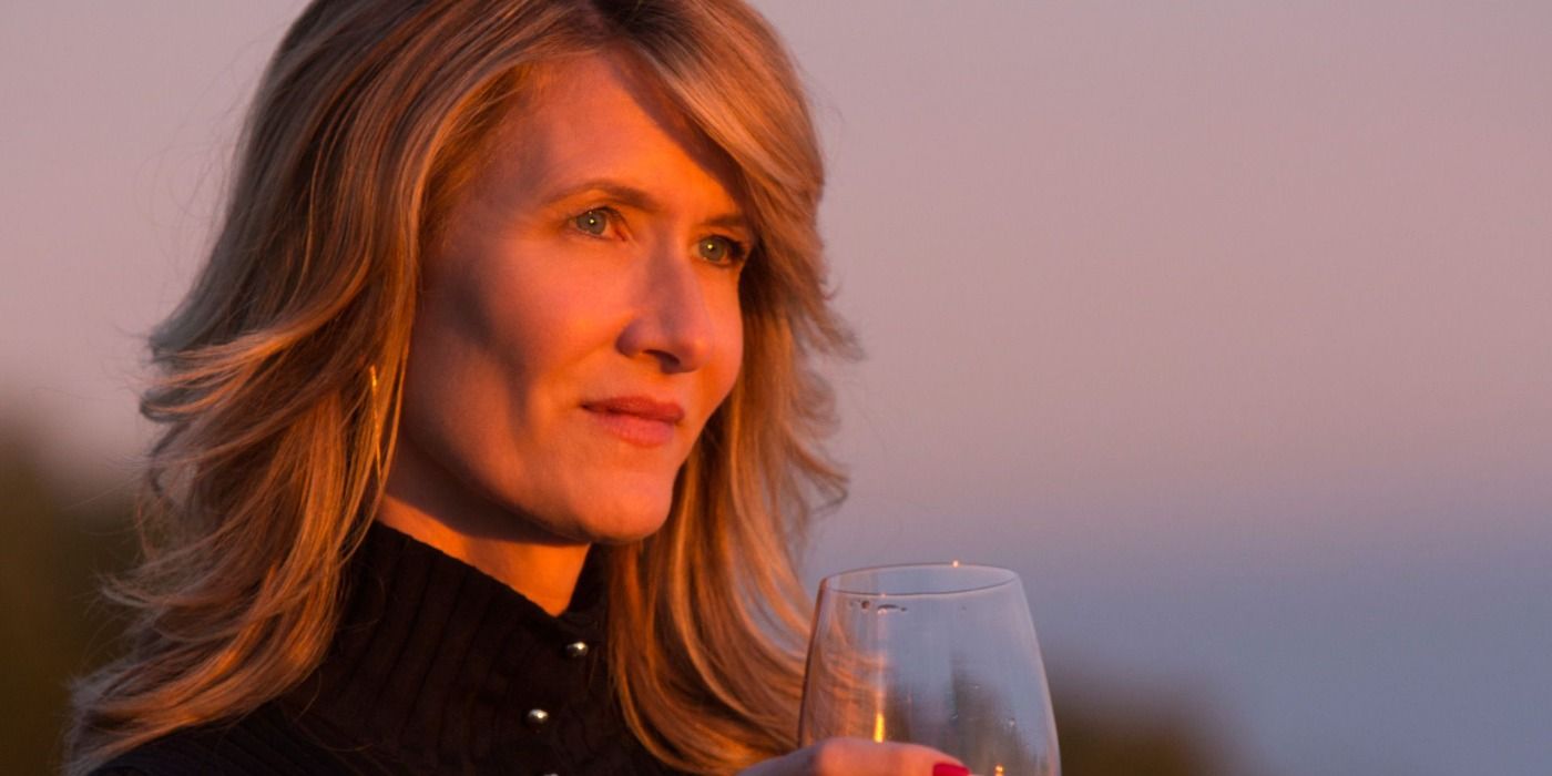 Renata holding a glass of wine in the sunset in Big Little Lies.