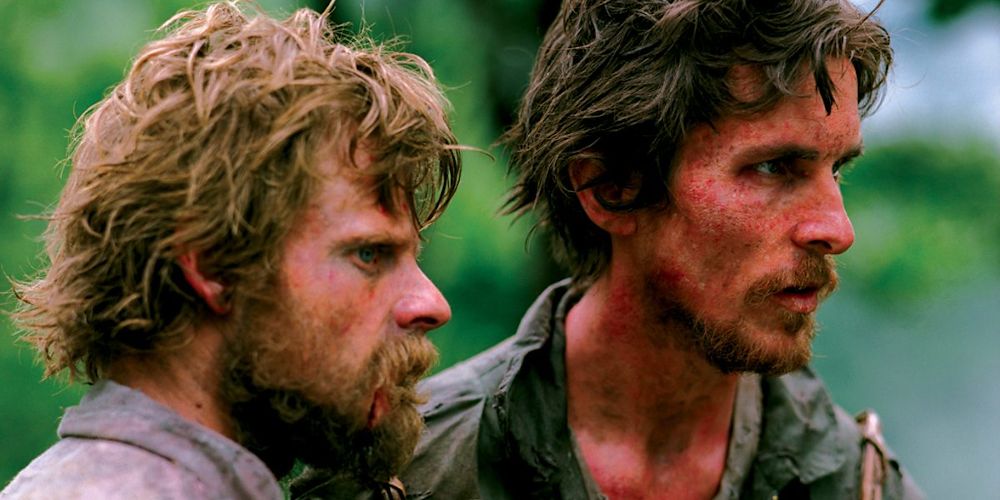 Christian Bale and Steve Zahn looking at something off-screen in Rescue Dawn