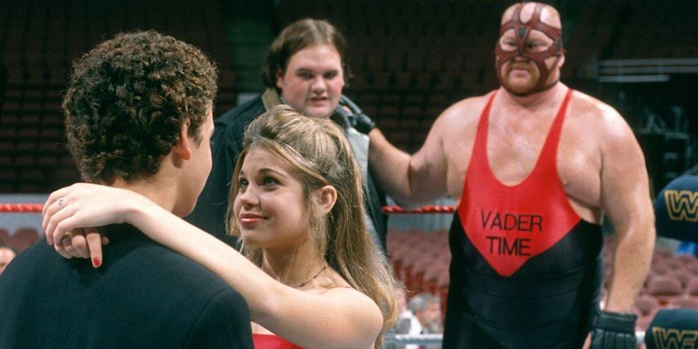 Cory dances with Topanga in a wrestling ring as Vader and his son watch