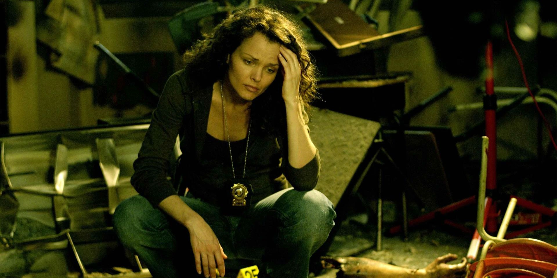 Allison Kerry (Dina Meyer) kneeling at crime scene in Saw