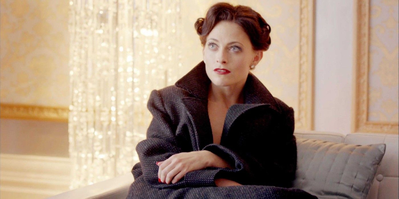 Irene Adler sitting down and looking up in Sherlock 