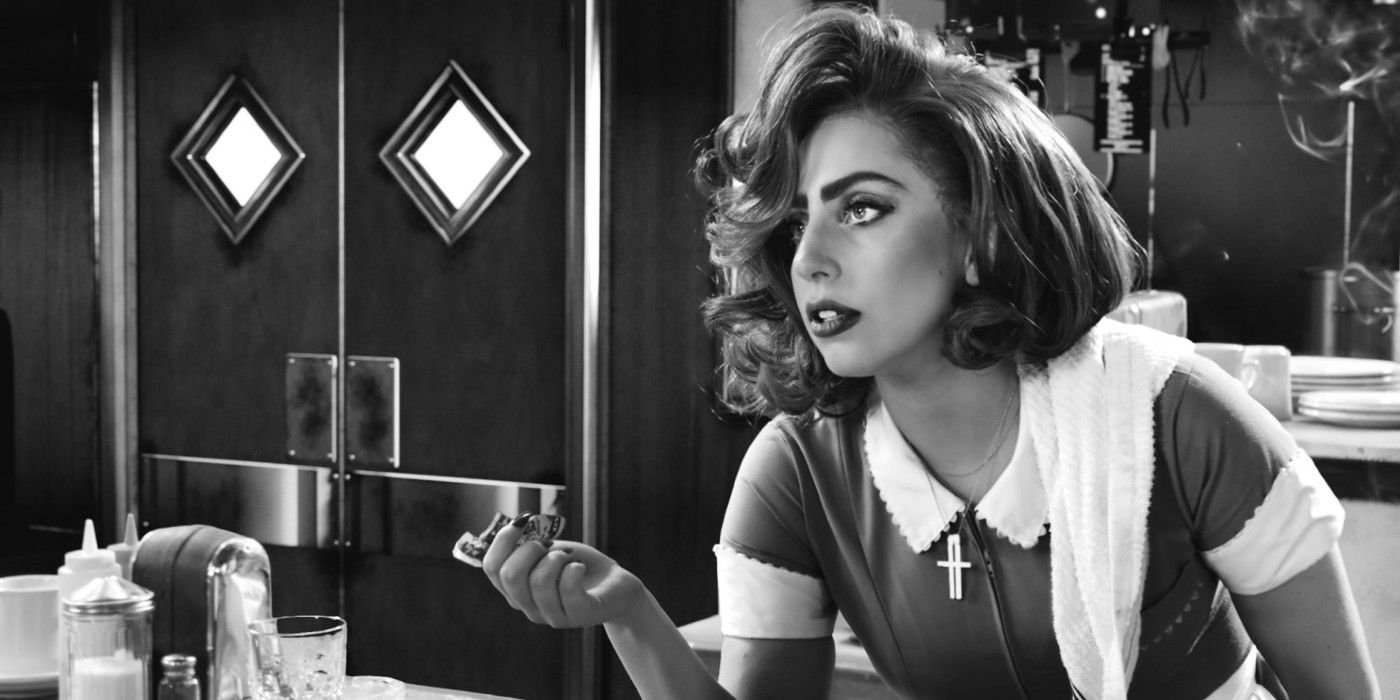 Lady Gaga as a waitress handing over a dollare bill in Sin City : A Dame To Kill For.