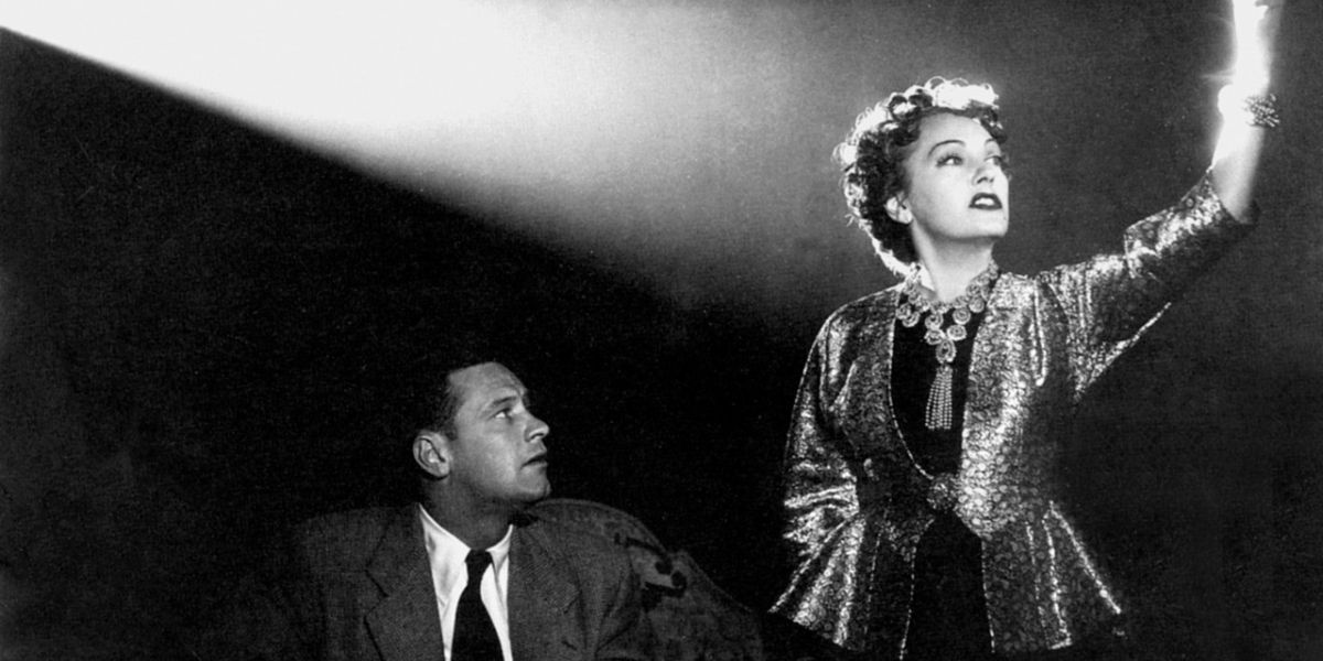 Norma stands in a theatre in Sunset Blvd.