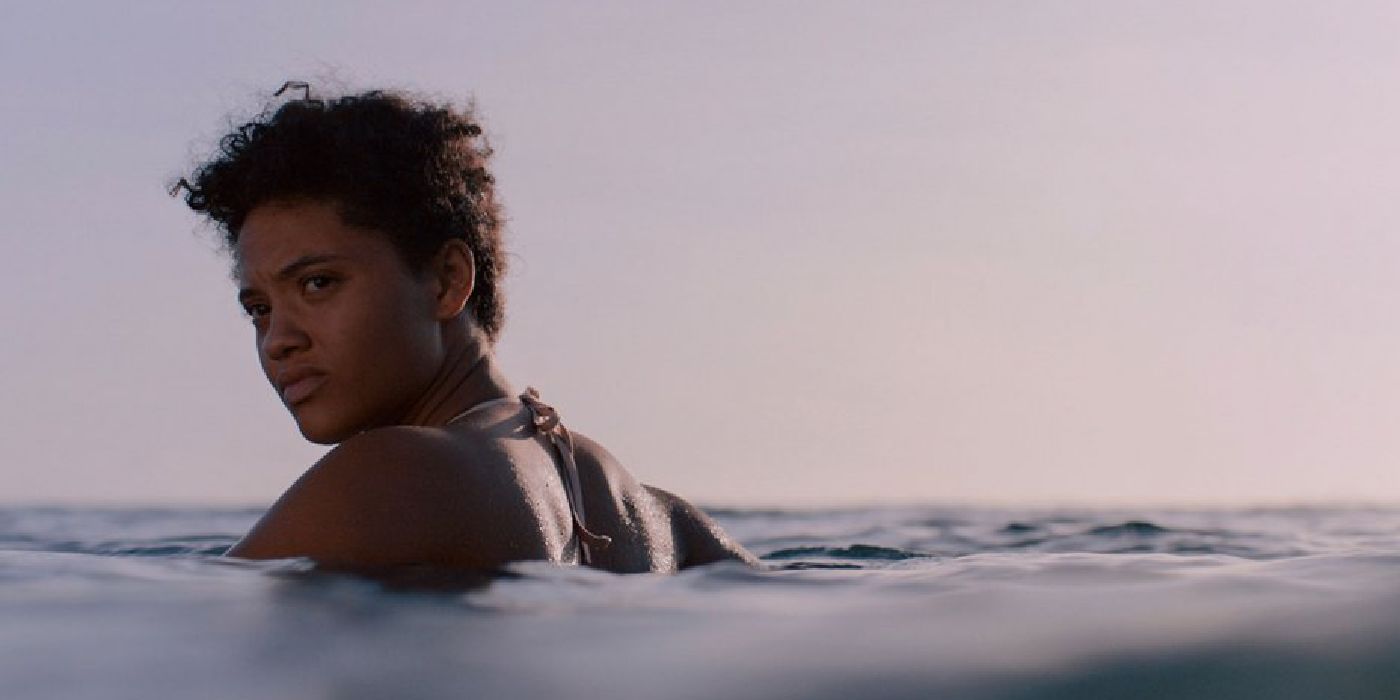 Kiersey Clemons looks behind her while standing in a lake in Sweetheart.