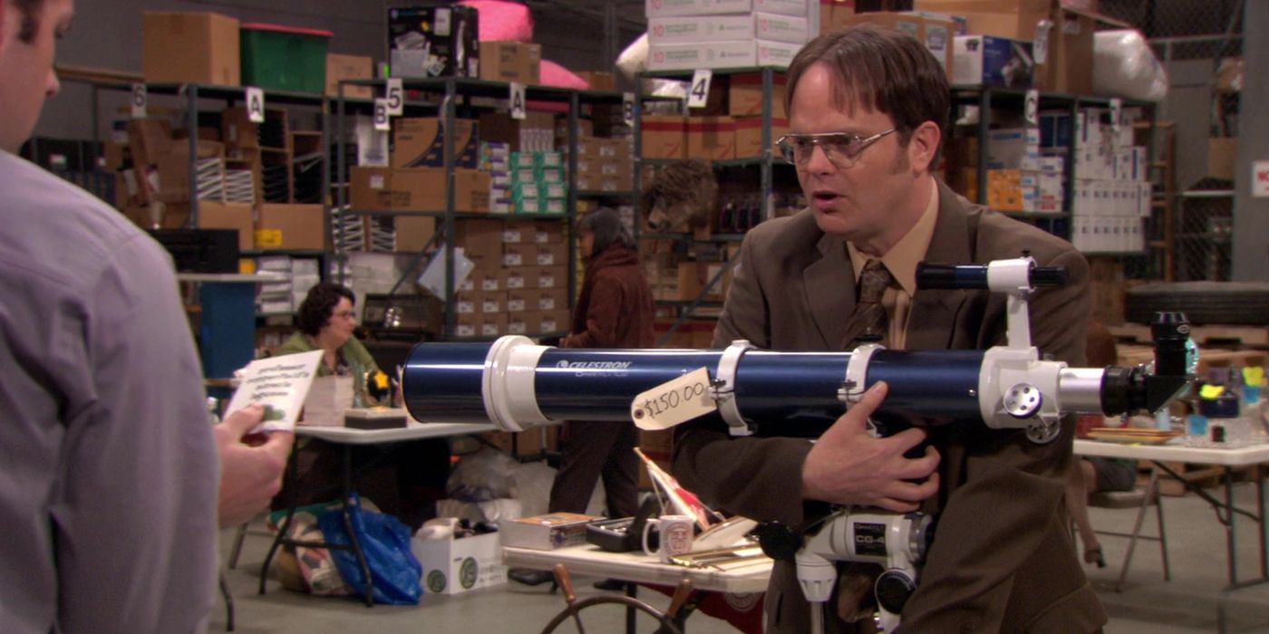 Dwight holds a telescope