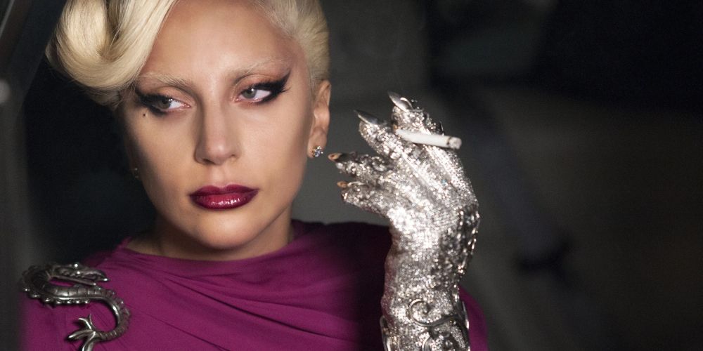 Lady Gaga as the Countess, smoking a cigarette